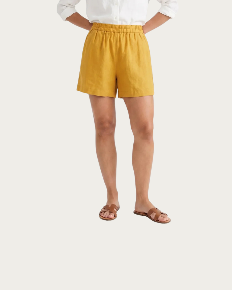 woman wearing yellow linen shorts summer outfit front view