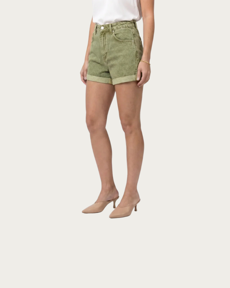 woman wearing green shorts casual summer outfit front view