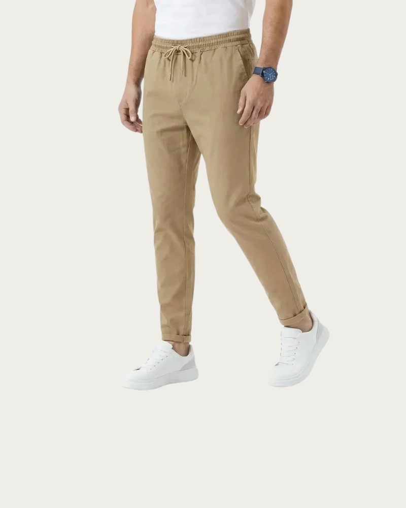 man wearing beige stretch trousers full body casual outfit