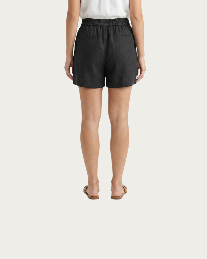 woman wearing black linen shorts back view relaxed fit