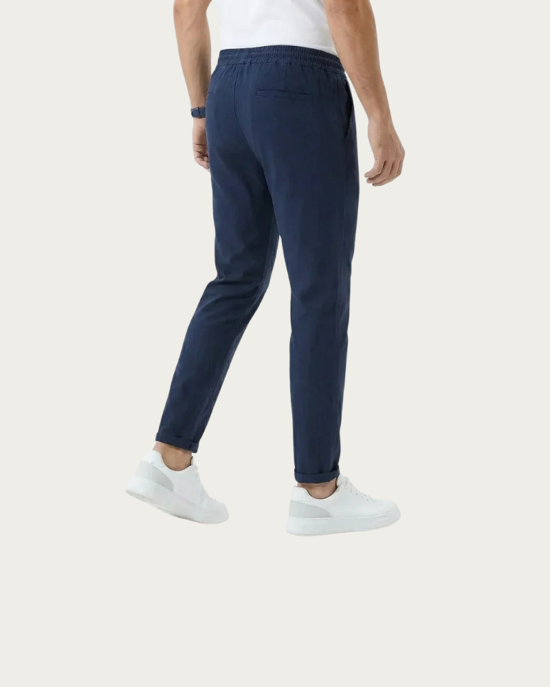 man wearing navy tapered trousers side view casual styling