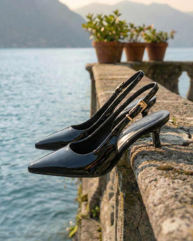 multiple slingback heels placed on railing near water view