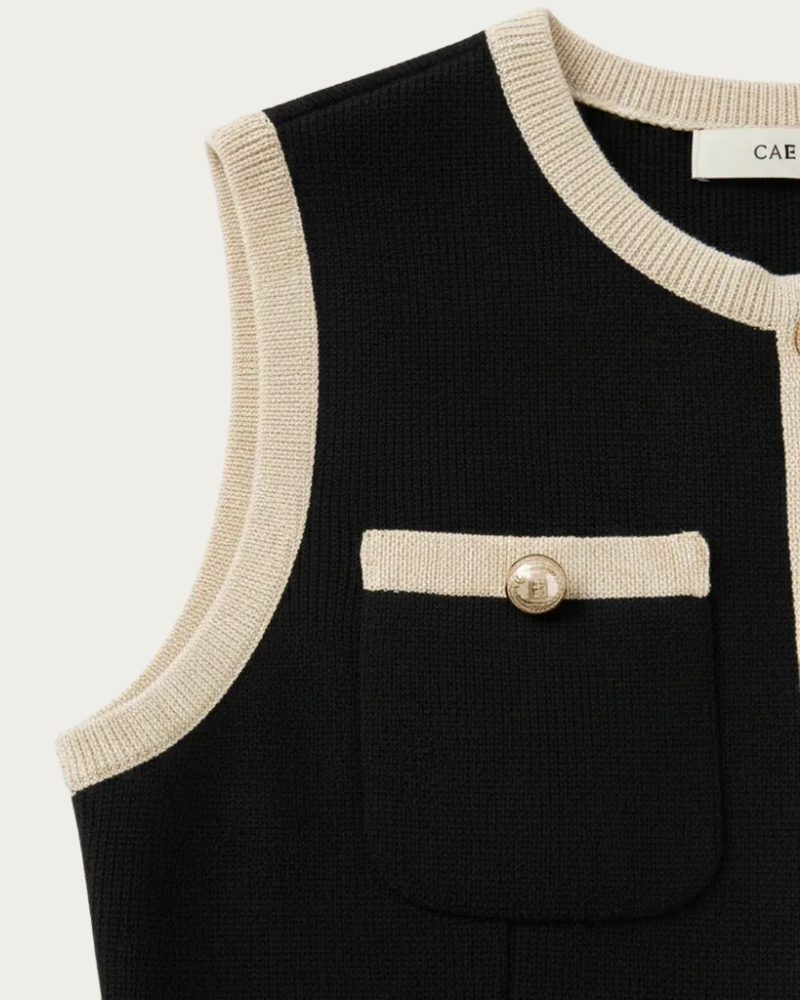 close up of black knit dress pocket detail with contrast trim