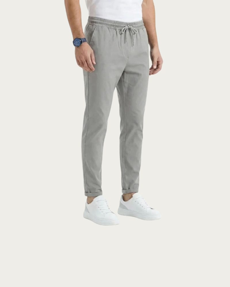 man wearing grey tapered trousers casual outfit front view