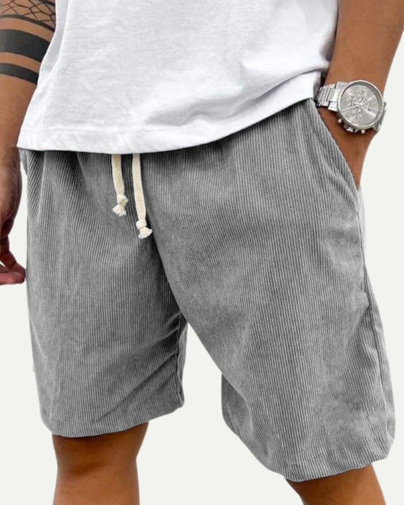 man wearing grey corduroy shorts relaxed fit summer look