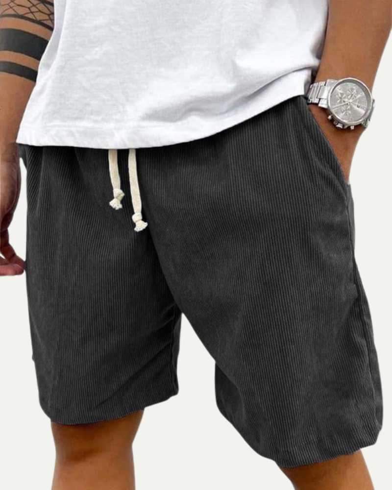 man wearing dark grey corduroy shorts relaxed summer outfit