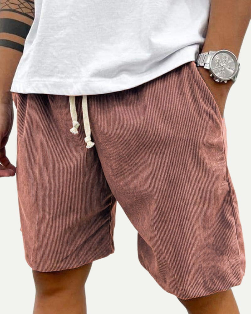 man wearing pink corduroy shorts relaxed fit outdoor look